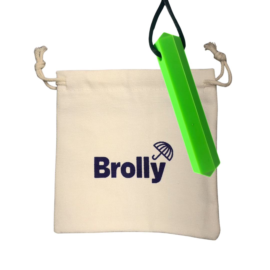 Beige drawstring pouch and Gem-shaped Brolly Chew Necklace on a black cord against a white background - Green