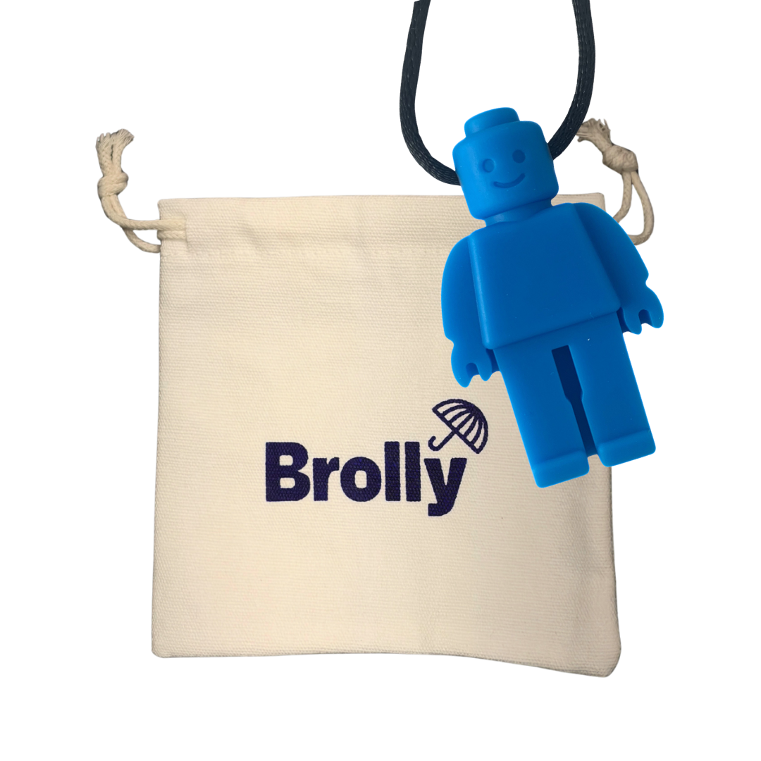 Beige drawstring pouch and Robot-shaped Brolly Chew Necklace on a black cord against a white background - Blue