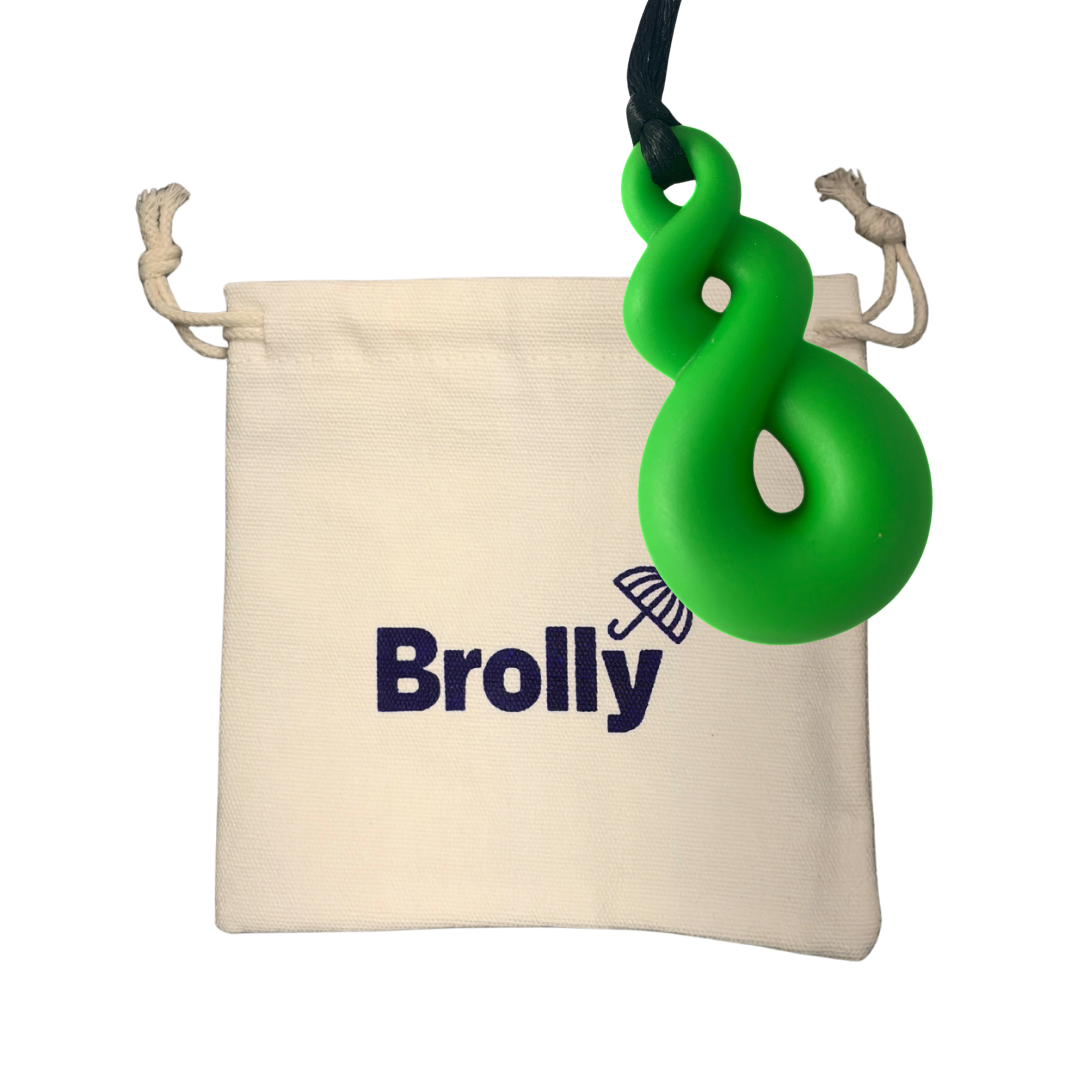 Beige drawstring pouch and Twist-shaped Brolly Chew Necklace on a black cord against a white background - Green