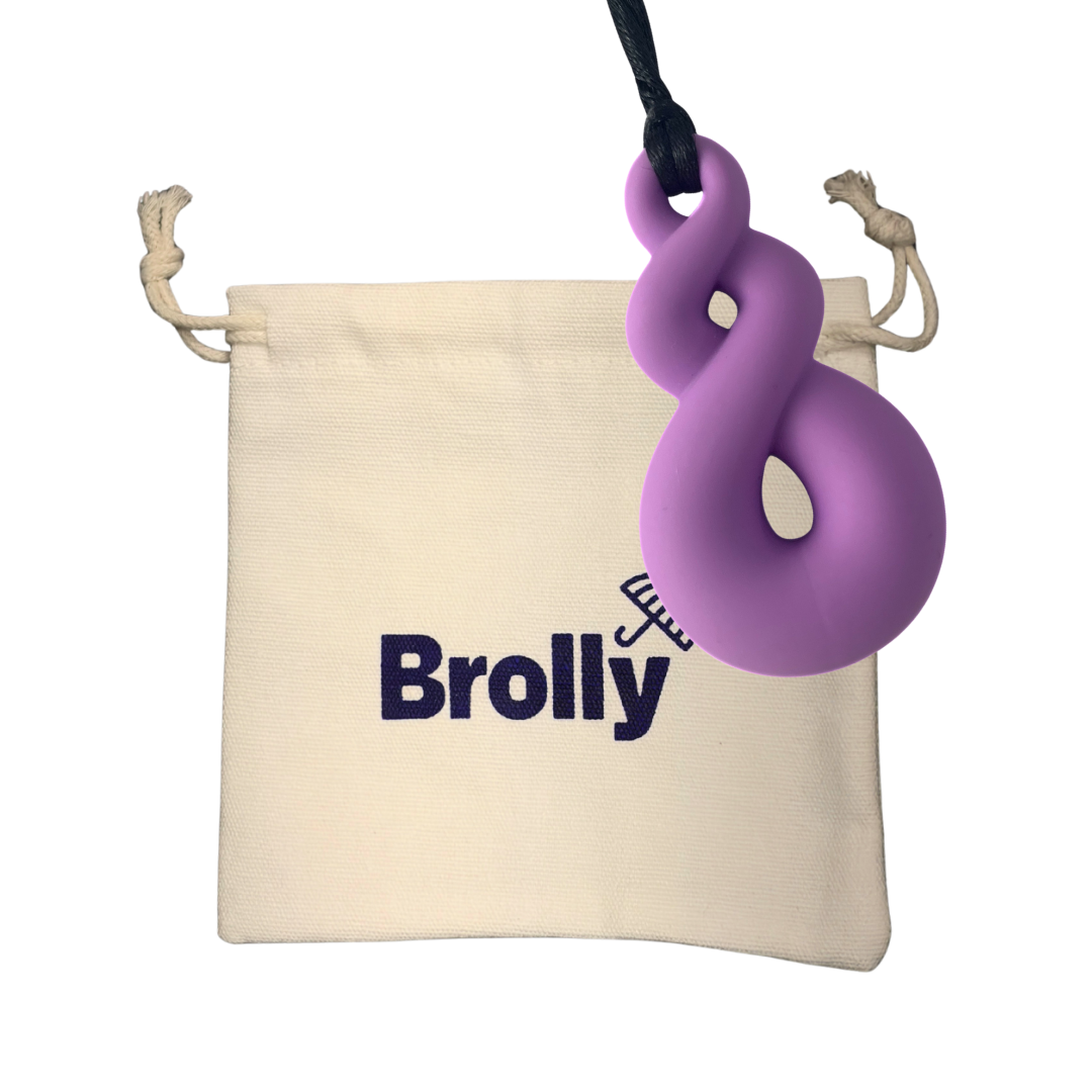 Beige drawstring pouch and Twist-shaped Brolly Chew Necklace on a black cord against a white background - Purple