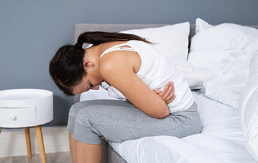 women hold herself with a tummy pain