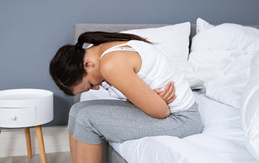 women hold herself with a tummy pain