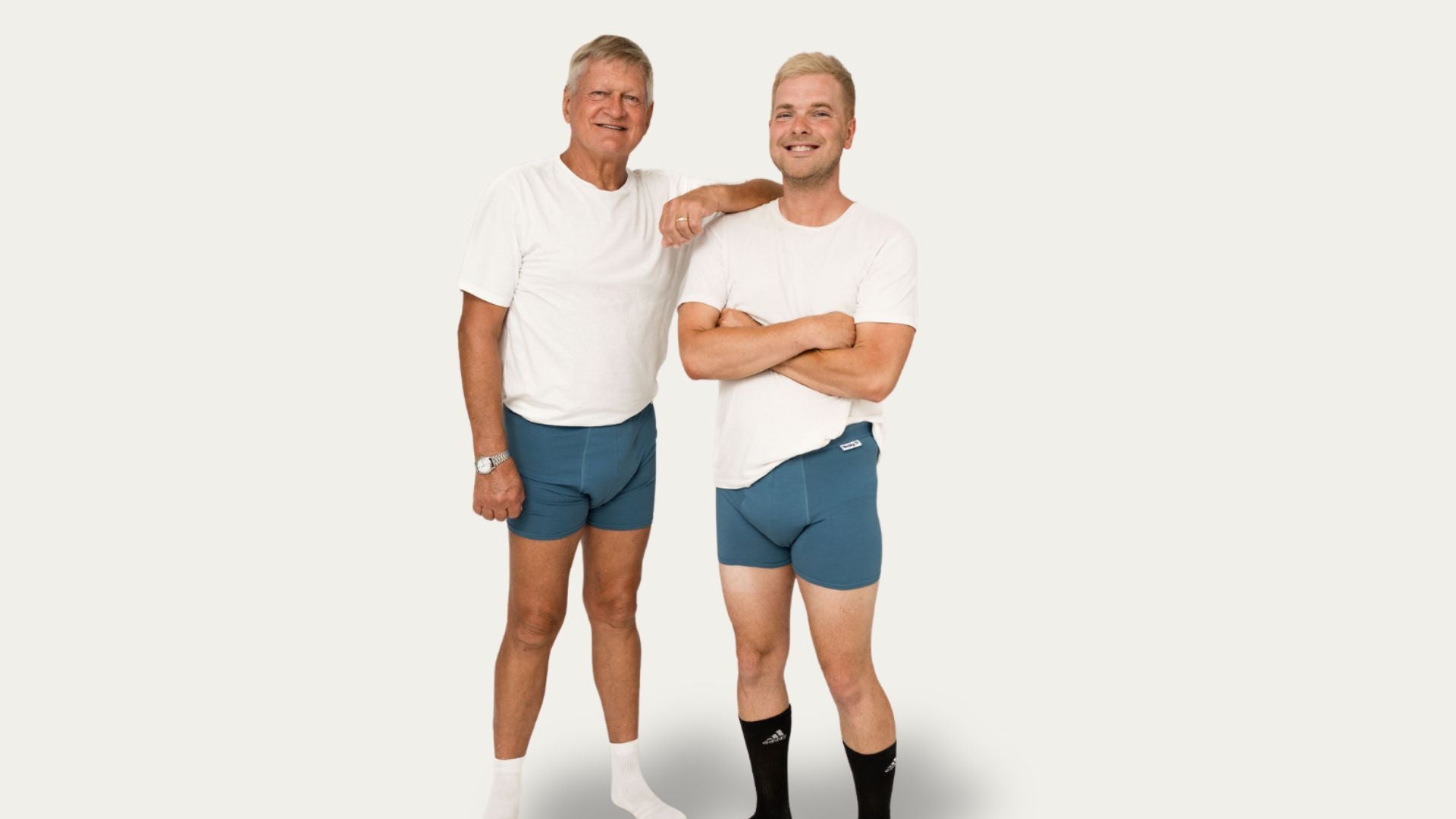 Two men wearing Brolly Sheets men’s absorbent underwear, standing in a neutral setting to show fit, coverage, and discreet protection.