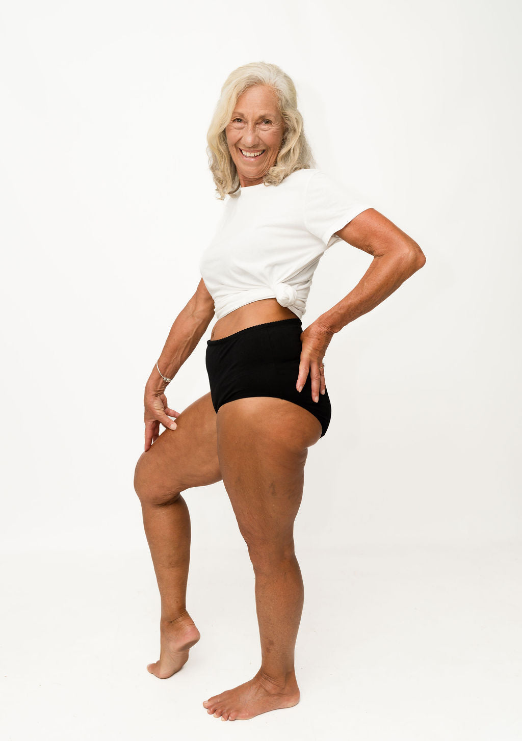 Woman wearing a white tank top and Brolly underwear on a white background - Black