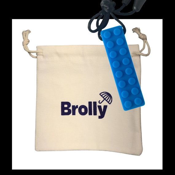 Beige drawstring pouch and Shark Tooth-shaped Brolly Chew Necklace on a black cord against a white background - Blue