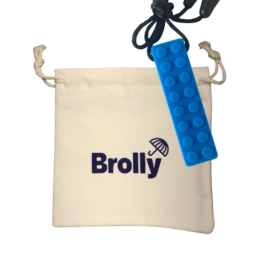 Beige drawstring pouch and Blue brick-shaped Brolly Chew Necklace on a black cord against a white background - Blue