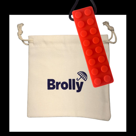 Beige drawstring pouch and Shark Tooth-shaped Brolly Chew Necklace on a black cord against a white background - Blue