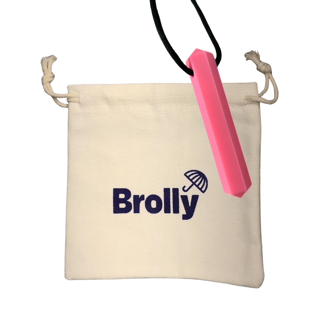 Beige drawstring pouch and Gem-shaped Brolly Chew Necklace on a black cord against a white background - Pink