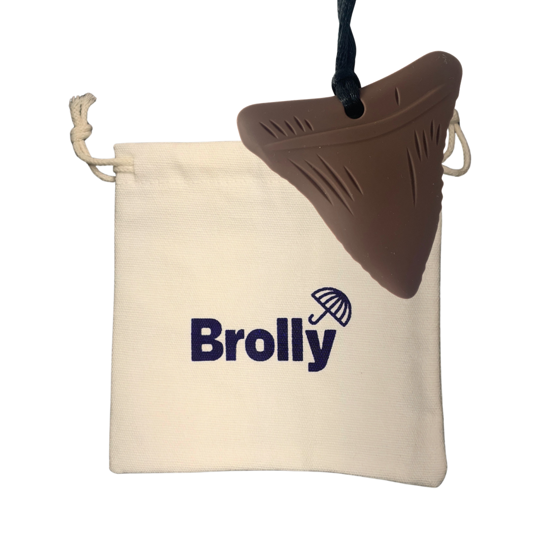 Beige drawstring pouch and Shark Tooth-shaped Brolly Chew Necklace on a black cord against a white background - Brown