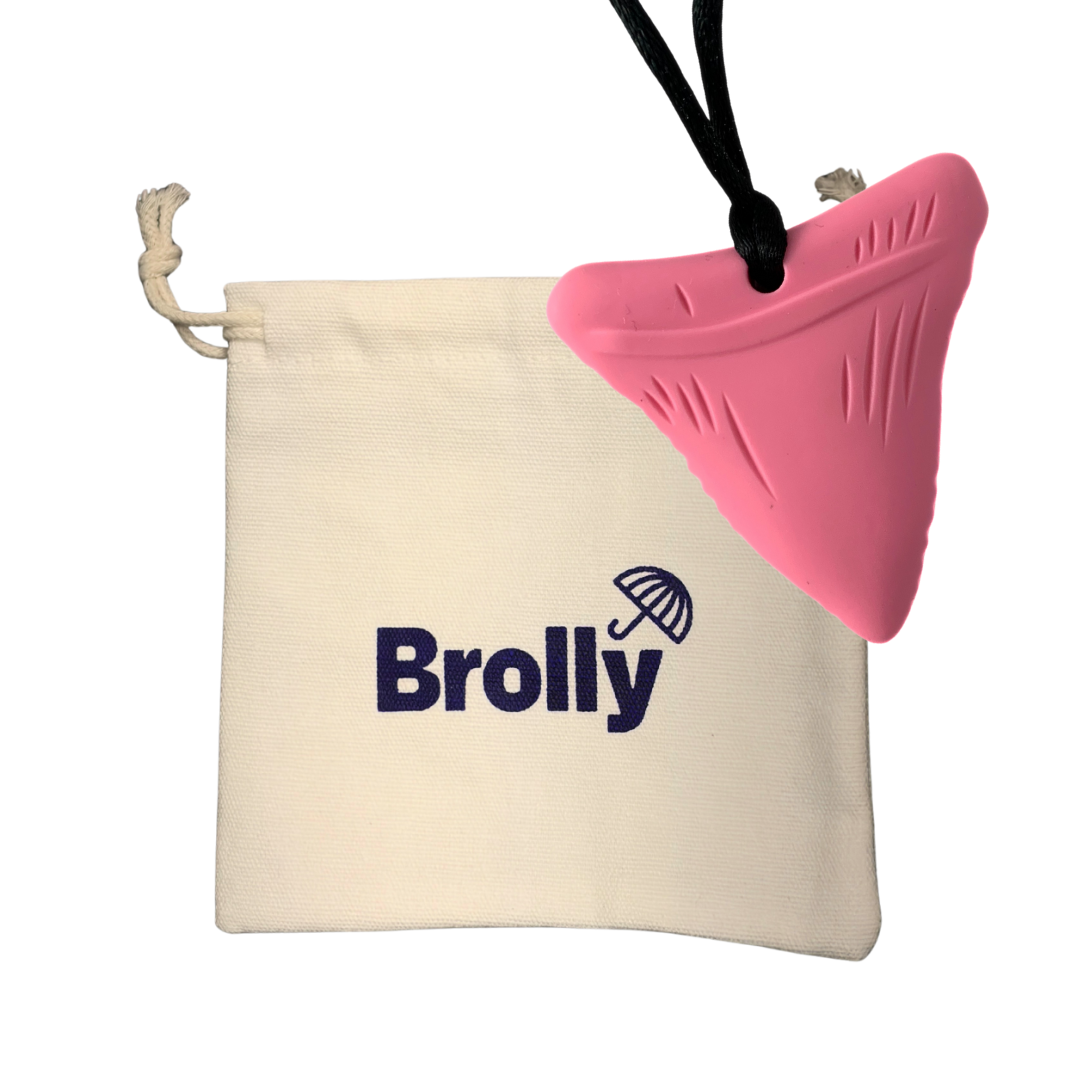 Beige drawstring pouch and Shark Tooth-shaped Brolly Chew Necklace on a black cord against a white background - Pink