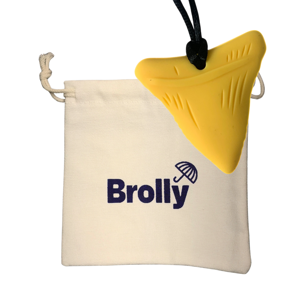 Beige drawstring pouch and Shark Tooth-shaped Brolly Chew Necklace on a black cord against a white background - Mustard