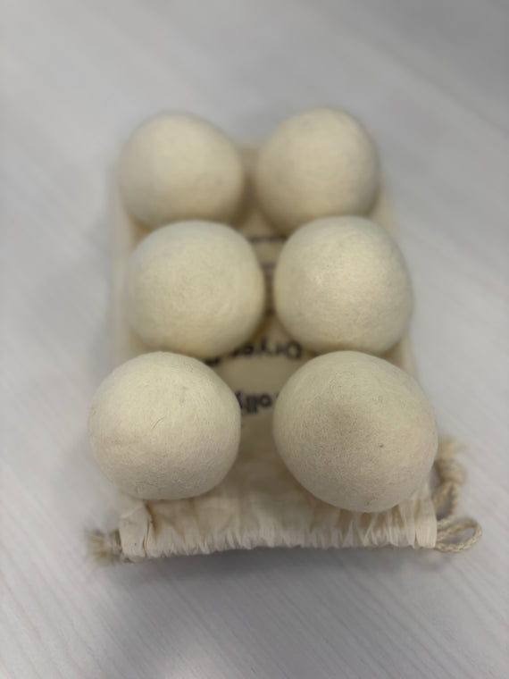 four NZ Wool Dryer Balls on cotton bag