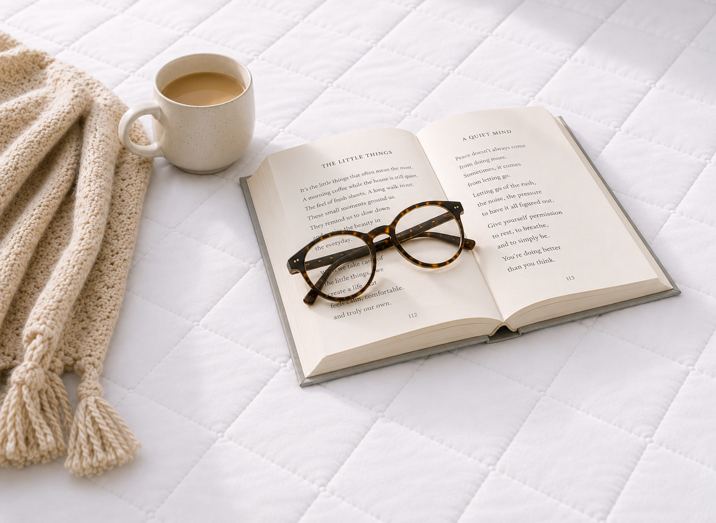 lifestyle shot, book and coffee on essential mattress protector white soft quilted microfibre top